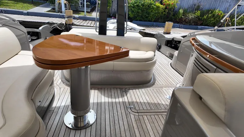  Yacht Photos Pics Luxurious 2012 Riva Rivale yacht interior with elegant seating and wooden table.