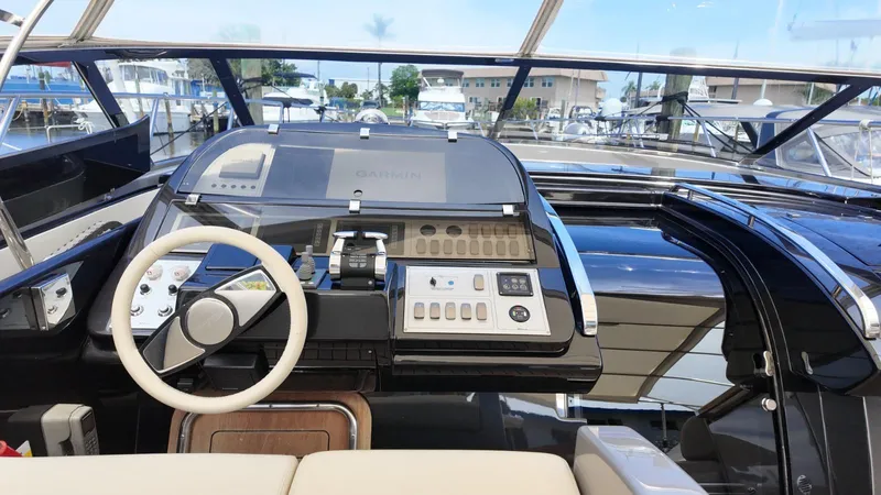  Yacht Photos Pics Helm of 2012 Riva Rivale yacht with modern controls and Garmin navigation system.