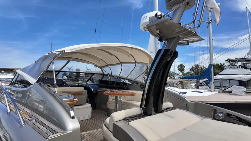  Yacht Photos Pics 2012 Riva Rivale yacht with sleek design, docked under clear blue sky.