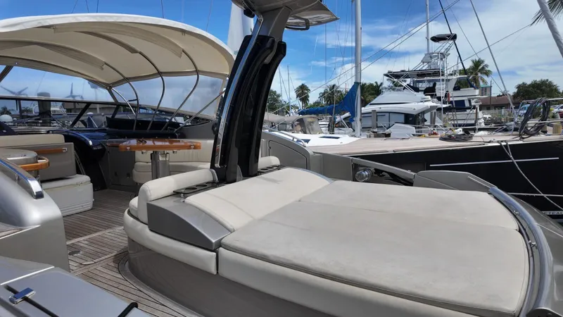  Yacht Photos Pics Luxurious 2012 Riva Rivale yacht interior with elegant seating and wooden accents in a marina setting.