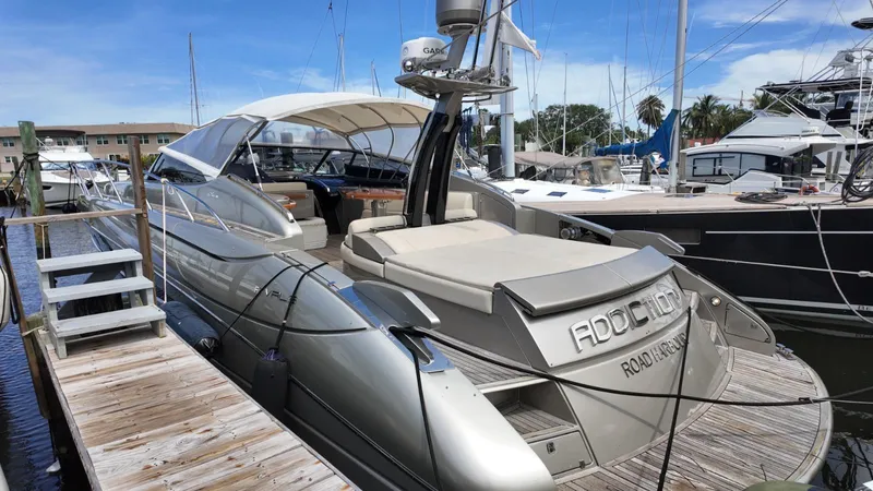  Yacht Photos Pics 2012 Riva Rivale yacht docked at marina under clear blue sky.