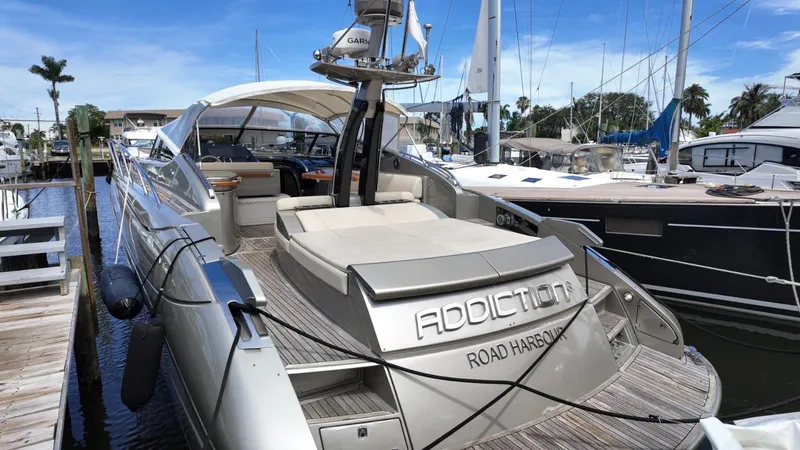  Yacht Photos Pics Luxury 2012 Riva Rivale yacht docked at marina, featuring sleek design and spacious deck.