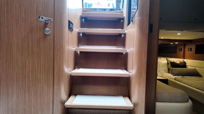  Yacht Photos Pics Interior of 2012 Riva Rivale yacht featuring wooden stairs and cozy seating area.
