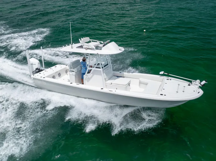  Yacht Photos Pics 2023 Canyon Bay 28h boat cruising on clear ocean waters.