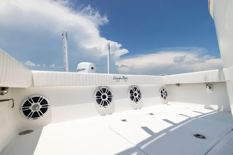  Yacht Photos Pics 2023 Canyon Bay 28h boat deck with speakers under a clear blue sky.
