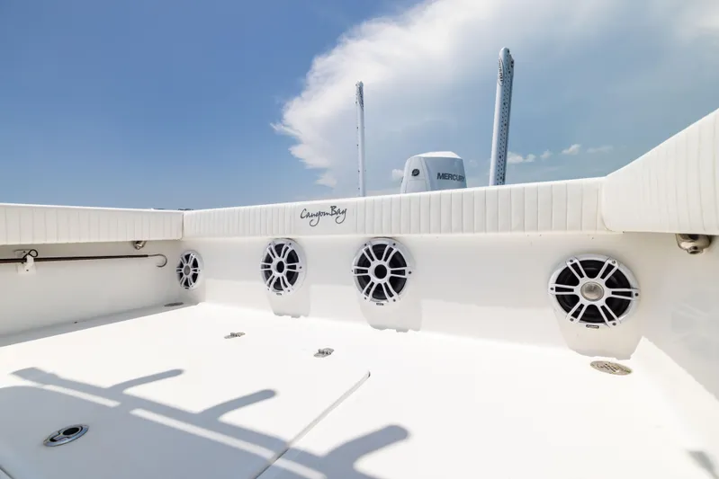  Yacht Photos Pics 2023 Canyon Bay 28h boat deck with speakers and clear sky.