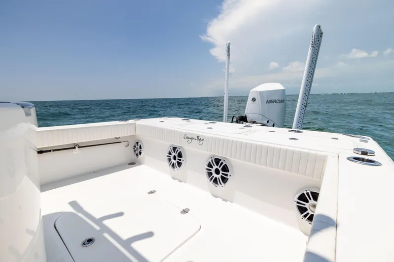  Yacht Photos Pics 2023 Canyon Bay 28h boat on open water, featuring spacious deck and Mercury engine.