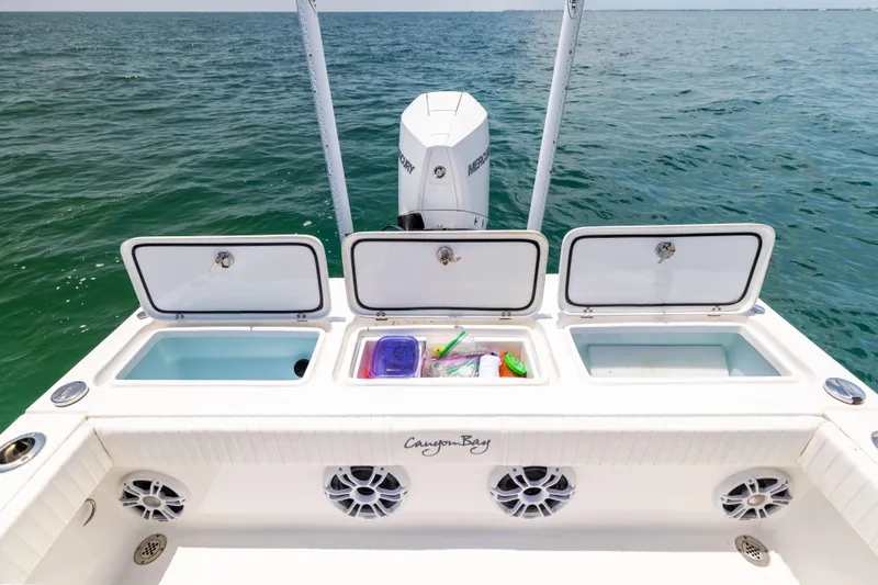  Yacht Photos Pics 2023 Canyon Bay 28h boat with open storage compartments on the ocean.