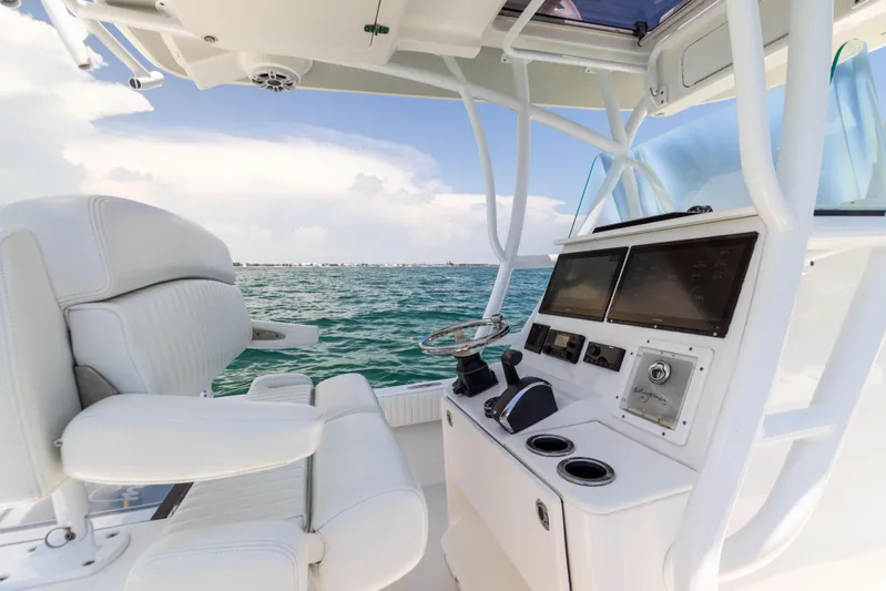  Yacht Photos Pics Canyon Bay 28h boat interior, 2023 model, featuring modern controls and seating on open water.