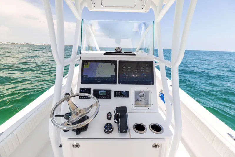  Yacht Photos Pics 2023 Canyon Bay 28h boat console with navigation screens on open water.