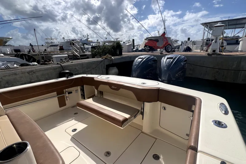 Bachita Yacht Photos Pics 2023 Scout 355 LXF boat interior at marina with twin outboard engines.