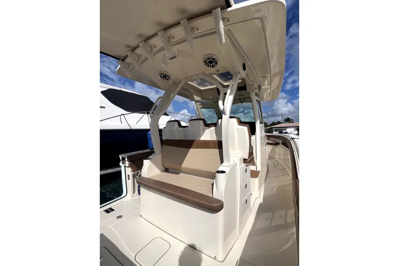 Bachita Yacht Photos Pics 2023 Scout 355 LXF boat interior with seating and overhead canopy.