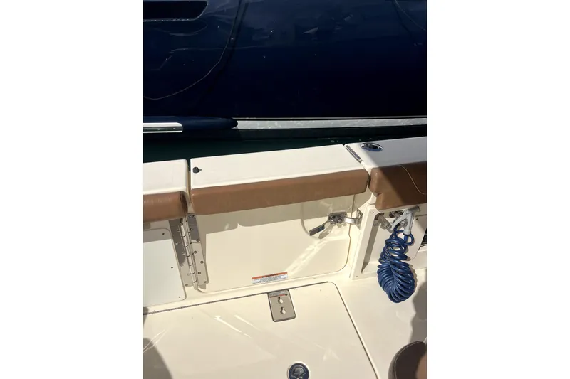 Bachita Yacht Photos Pics 2023 Scout 355 LXF boat interior with seating and coiled blue hose.