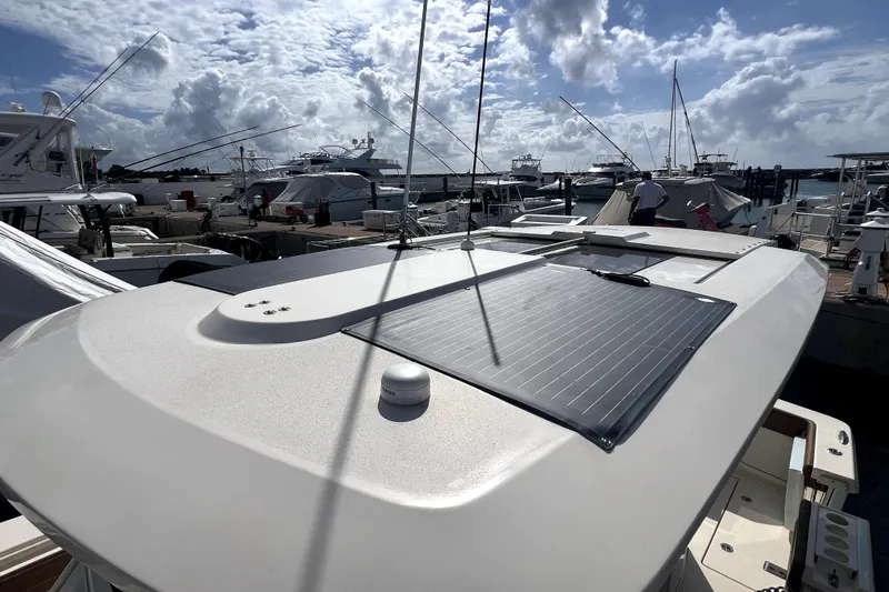 Bachita Yacht Photos Pics 2023 Scout 355 LXF boat docked under a cloudy sky.