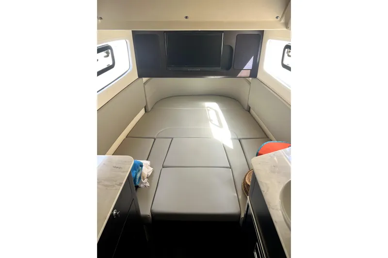 Bachita Yacht Photos Pics 2023 Scout 355 LXF cabin interior with bed and TV, featuring modern design.