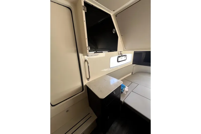 Bachita Yacht Photos Pics 2023 Scout 355 LXF cabin interior with seating and storage.