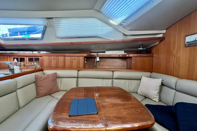 1754 Yacht Photos Pics Luxurious interior of 2004 Hunter 426 Owners Version yacht with plush seating and wooden table.