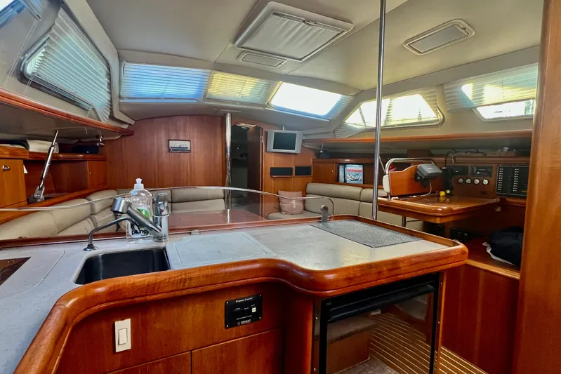1754 Yacht Photos Pics Interior of 2004 Hunter 426 Owners Version yacht with modern kitchen and seating area.