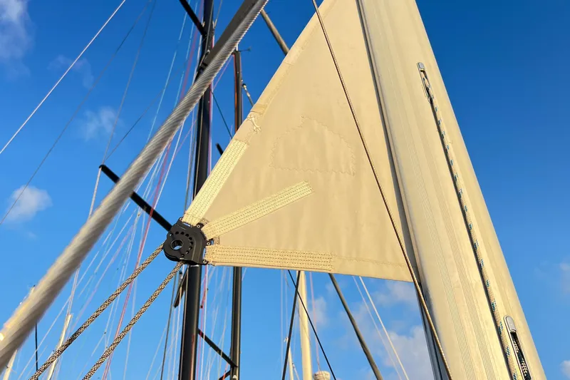 1754 Yacht Photos Pics Close-up of a 2004 Hunter 426 sailboat's rigging and sail against a clear blue sky.