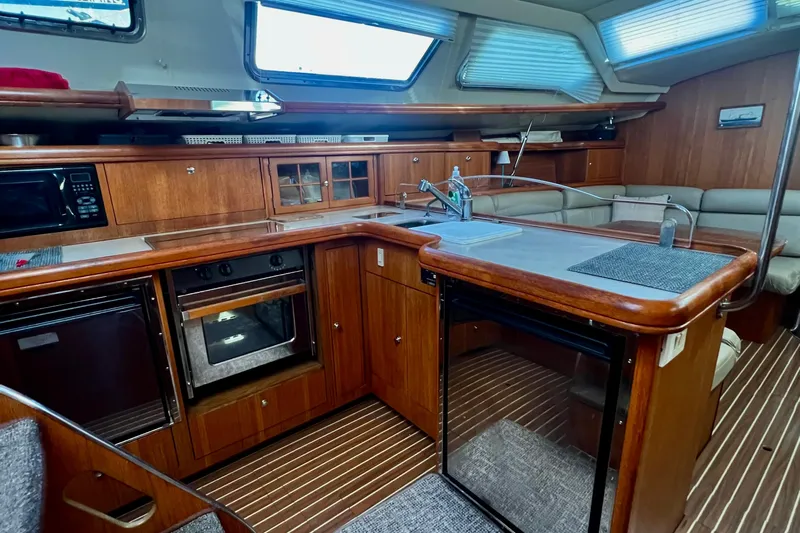 1754 Yacht Photos Pics Luxurious 2004 Hunter 426 Owners Version yacht interior with modern kitchen and seating area.