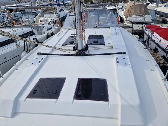  Yacht Photos Pics 2020 Hanse 508 yacht deck with hatches, docked among other boats.