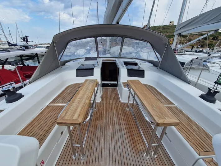  Yacht Photos Pics 2020 Hanse 508 yacht cockpit with wooden benches and sleek design in marina setting.