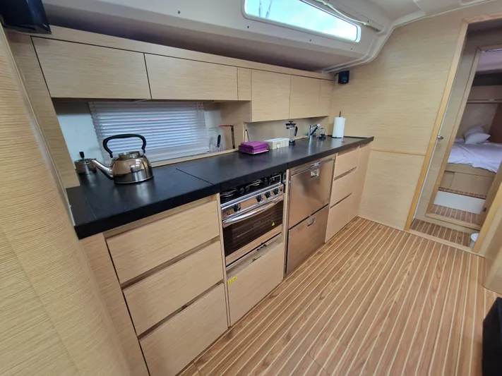  Yacht Photos Pics Modern kitchen interior of 2020 Hanse 508 yacht with sleek cabinetry and appliances.