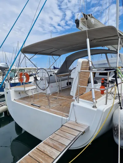  Yacht Photos Pics 2020 Hanse 508 yacht docked, featuring spacious deck and canopy under a partly cloudy sky.