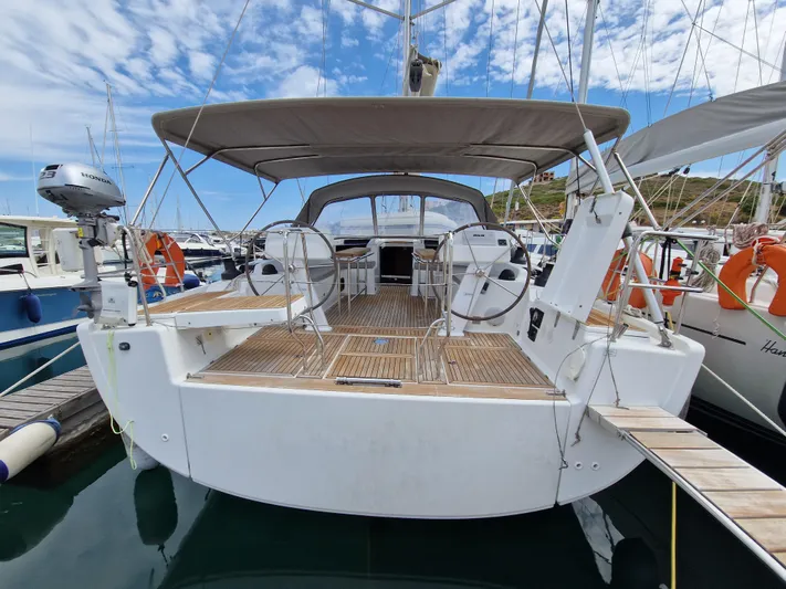  Yacht Photos Pics 2020 Hanse 508 yacht with spacious deck, docked in marina under blue sky.