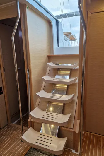  Yacht Photos Pics Interior stairs of 2020 Hanse 508 yacht, featuring modern wooden design and sleek metal accents.