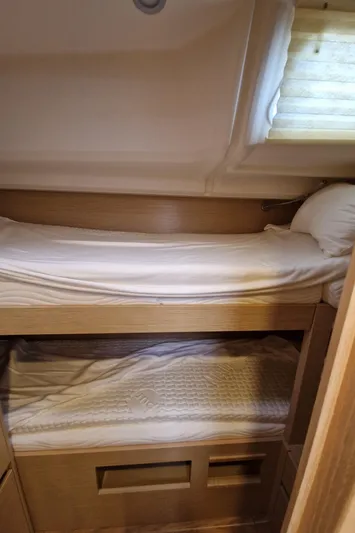  Yacht Photos Pics 2020 Hanse 508 yacht interior with cozy wooden bunk beds and soft lighting.