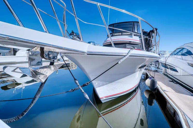 Radiant Yacht Photos Pics 1991 Californian 48 Sundeck Motor Yacht docked in marina, reflecting on calm water.