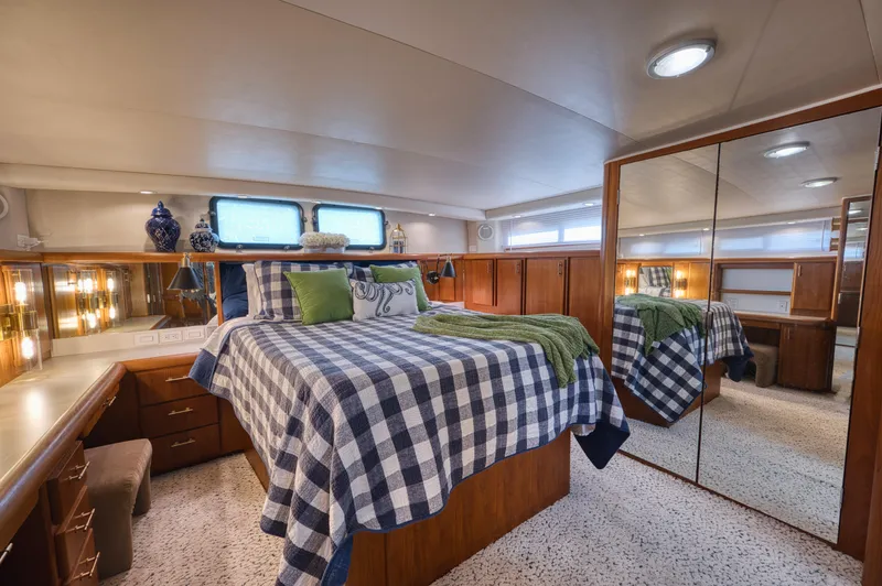 Radiant Yacht Photos Pics Luxurious bedroom in 1991 Californian 48 Sundeck Motor Yacht with elegant decor and mirrored closet.
