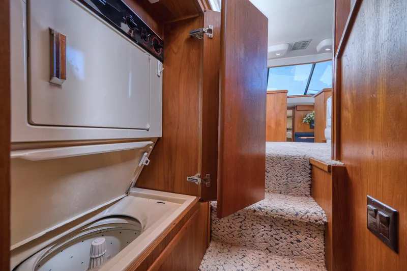 Radiant Yacht Photos Pics 1991 Californian 48 Sundeck Motor Yacht interior with washer and carpeted stairs.