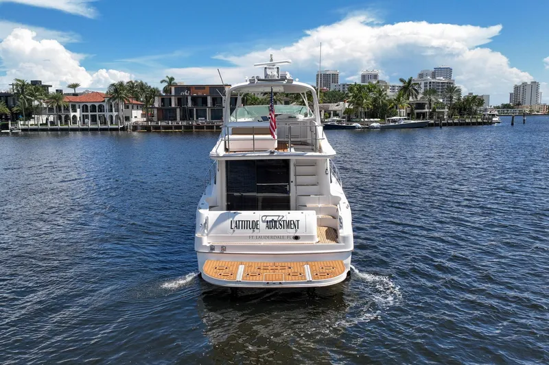 L'attitude Adjustment Yacht Photos Pics 2001 Sea Ray 540 Cockpit Motor Yacht cruising in a scenic waterfront setting.