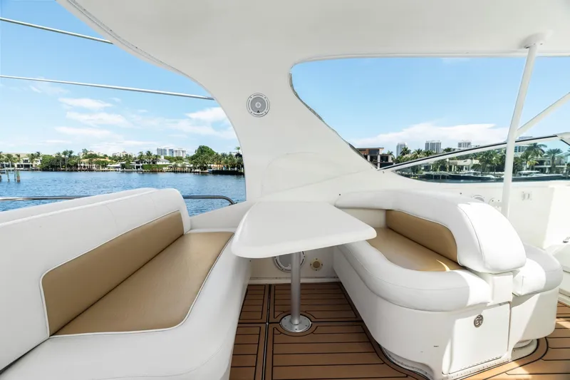 L'attitude Adjustment Yacht Photos Pics Luxurious seating area on 2001 Sea Ray 540 Cockpit Motor Yacht with waterfront view.