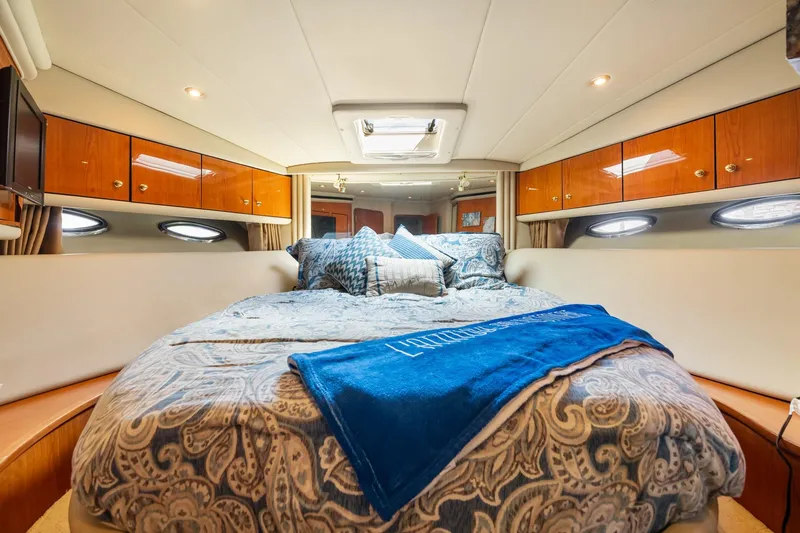 L'attitude Adjustment Yacht Photos Pics Luxurious bedroom interior of 2001 Sea Ray 540 Cockpit Motor Yacht with elegant bedding.