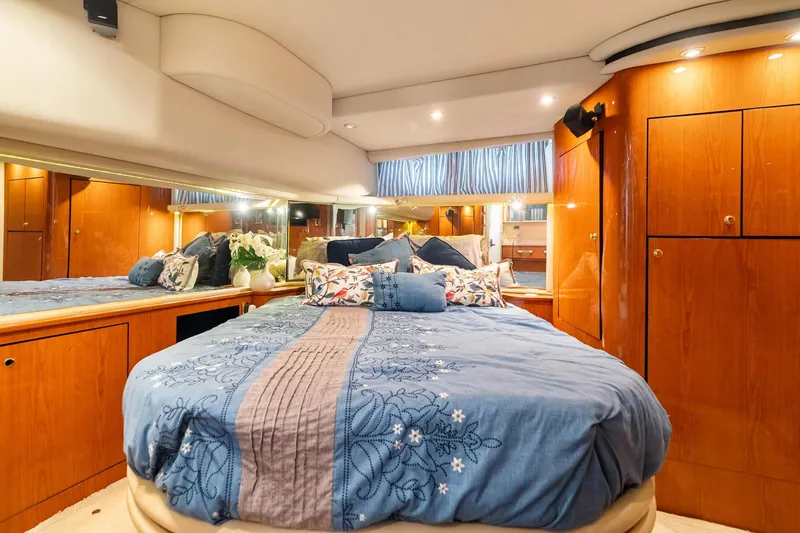 L'attitude Adjustment Yacht Photos Pics Luxurious bedroom interior of 2001 Sea Ray 540 Cockpit Motor Yacht with elegant wood cabinetry.