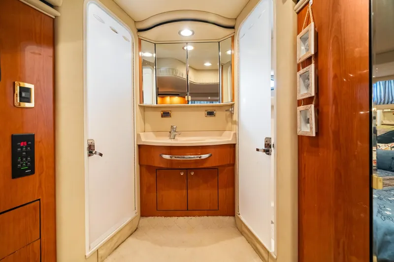 L'attitude Adjustment Yacht Photos Pics Luxurious bathroom interior of 2001 Sea Ray 540 Cockpit Motor Yacht with wood accents.