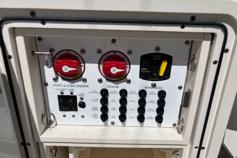  Yacht Photos Pics Electrical panel of a 2014 Pursuit C 310 Center Console boat, featuring switches and controls.