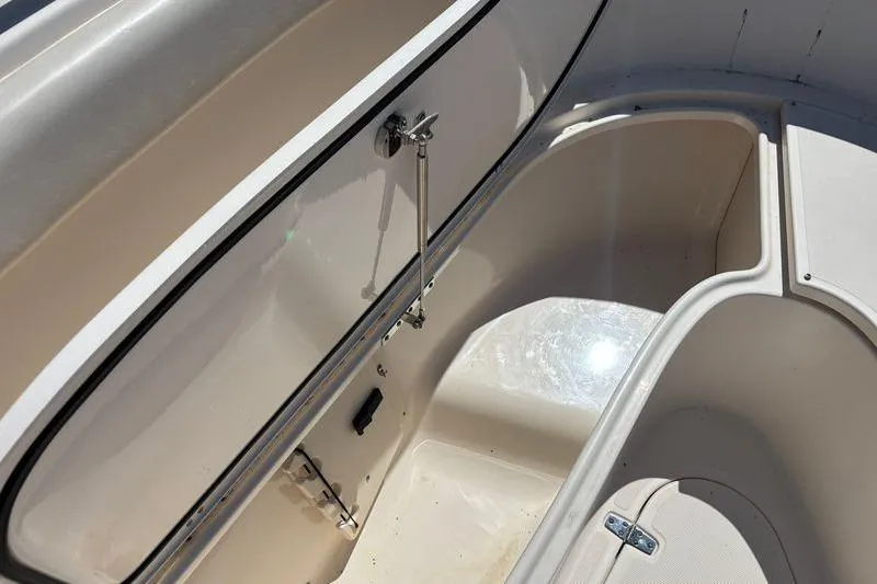  Yacht Photos Pics 2014 Pursuit C 310 Center Console storage compartment, open and sunlit.
