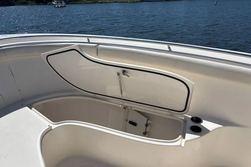  Yacht Photos Pics 2014 Pursuit C 310 Center Console boat storage compartment open on calm water.