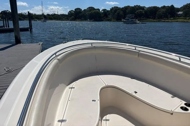 Yacht Photos Pics 2014 Pursuit C 310 Center Console boat docked by a scenic lake.
