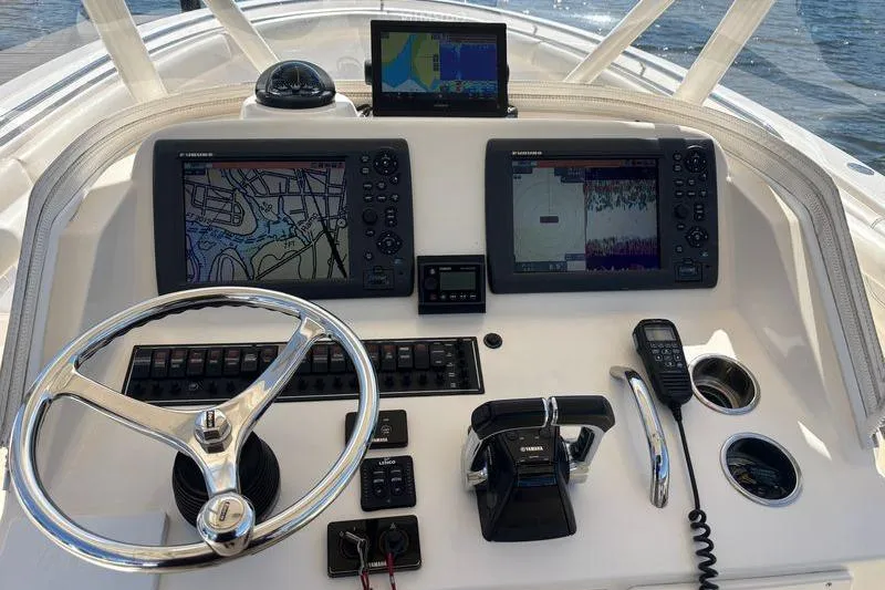  Yacht Photos Pics 2014 Pursuit C 310 Center Console dashboard with navigation screens and controls.