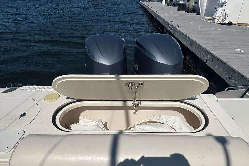  Yacht Photos Pics 2014 Pursuit C 310 Center Console boat with open storage compartment and twin engines.