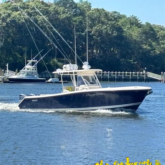  Yacht Photos Pics 2014 Pursuit C 310 Center Console boat cruising on a sunny day.