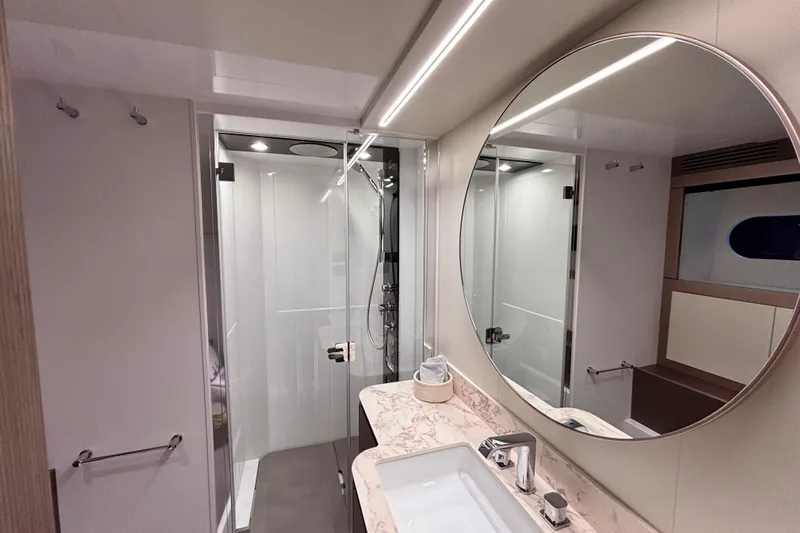 T&b Yacht Photos Pics Luxurious bathroom in 2025 Azimut Magellano 66 yacht with modern fixtures and elegant design.