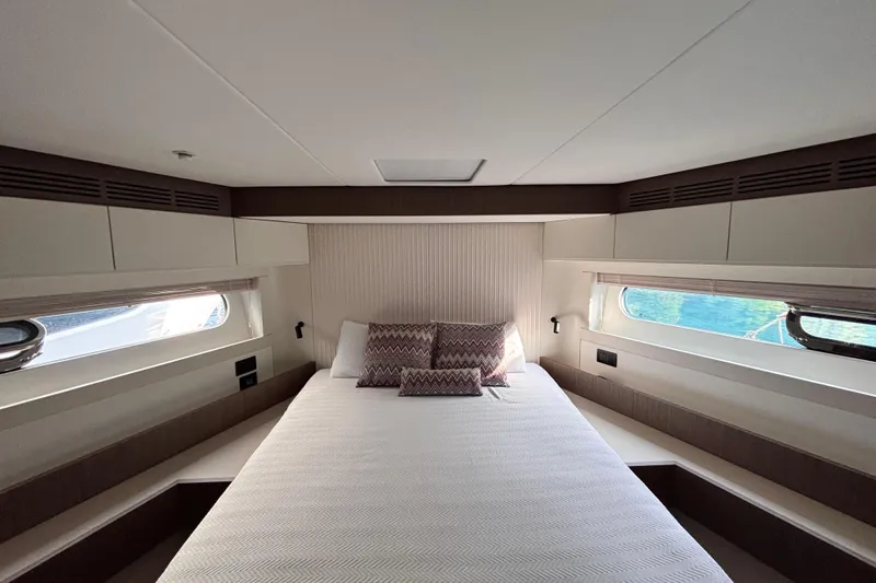 T&b Yacht Photos Pics Luxurious bedroom interior of 2025 Azimut Magellano 66 yacht with elegant bedding.