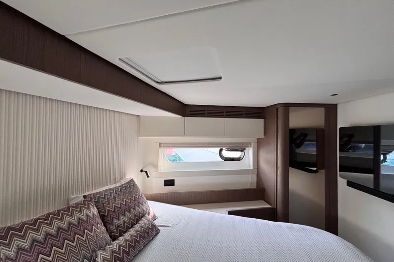 T&b Yacht Photos Pics Luxurious bedroom interior of 2025 Azimut Magellano 66 yacht with modern design elements.