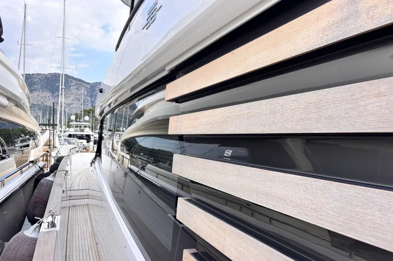 T&b Yacht Photos Pics Side view of 2025 Azimut Magellano 66 yacht docked in a marina.